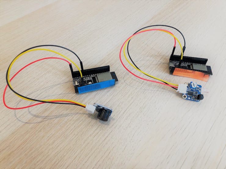 ESP32 with buzzer (left, blue) and ESP32 with IR Obstacle sensor (right, orange)