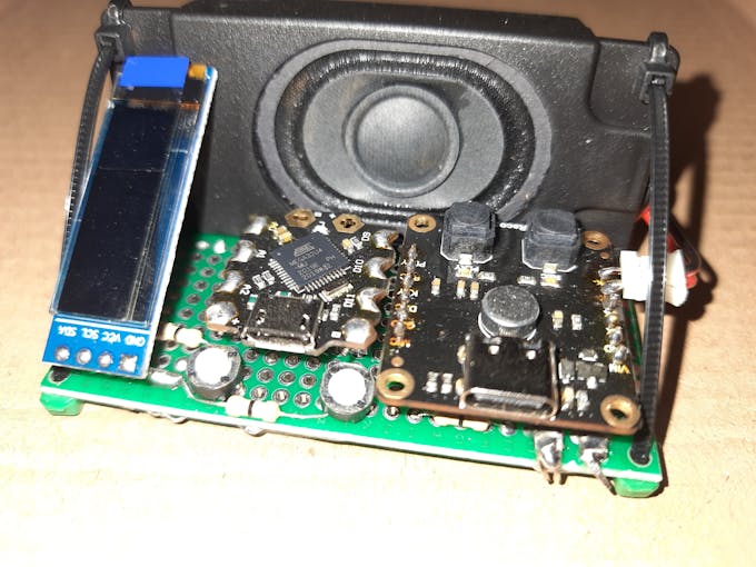 Cable ties holding speaker with the protoboard