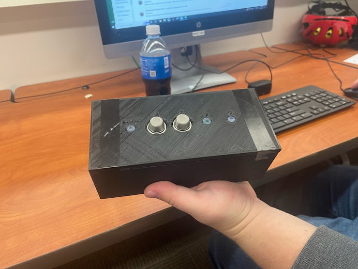 Figure 3: Circuit case with Sensors and LED's exposed, hand used for reference of size