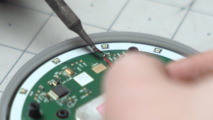 Soldering a sense line to the pad.