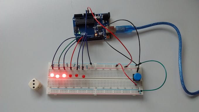 Dice throwing prototype using Arduino UNO, a button switch and 6 LEDs.