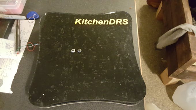 Black vinyl was put on the bottom of the top acrylic piece, then the "KitchenDRS" logo was cut to put on top.