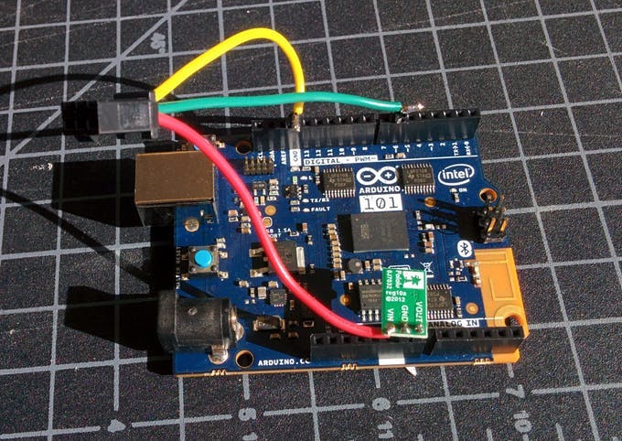 Top view showing connections. The pins "VOUT" and "GND" on the green voltage regulator go down into the Arduino 101.