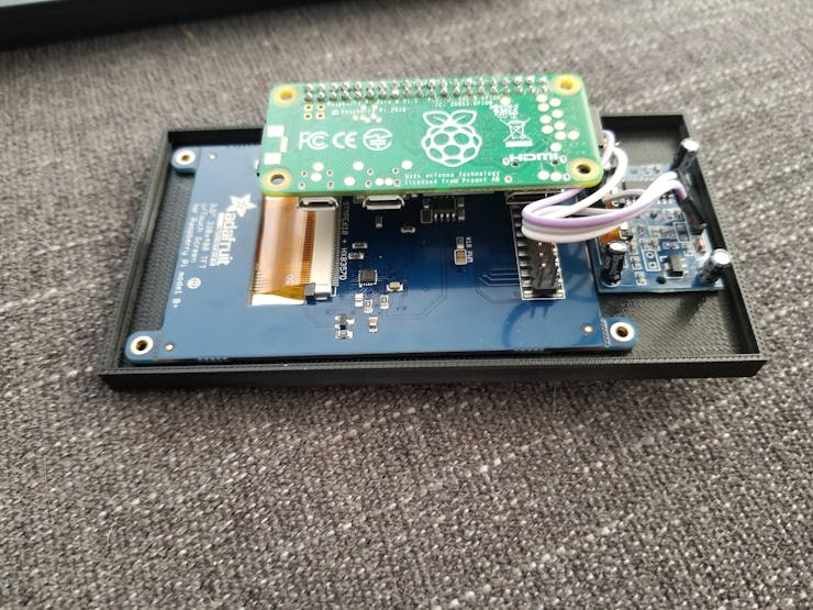 Display, Pi, and PIR sensor mounted onto the face plate just before adding hot glue.
