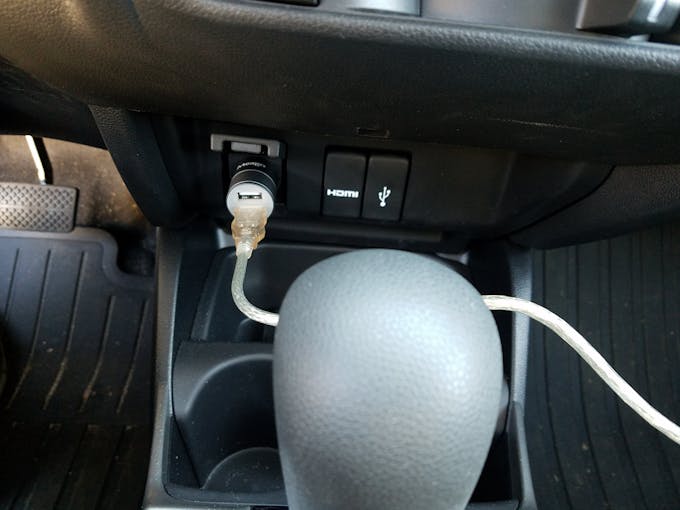 Just plug the Arduino into the car USB adapter to power it!