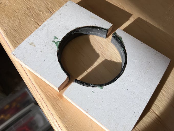 to clamp the drain pipe I padded the wood with some EPDM rubber