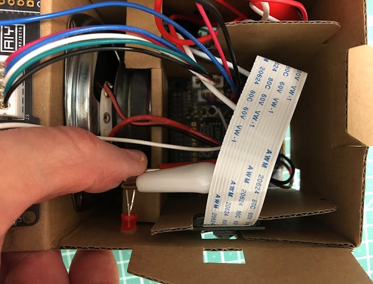 Push the LED into the cardboard 