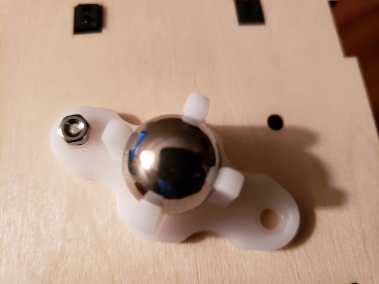 Orientate mainboard and attach universal wheel using M3*12 screw and nut