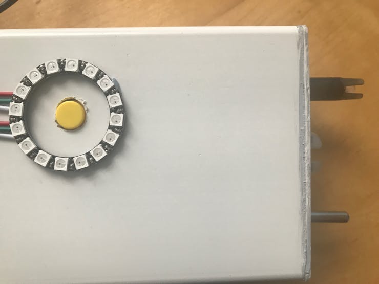 Place the button through and place the LED ring around it