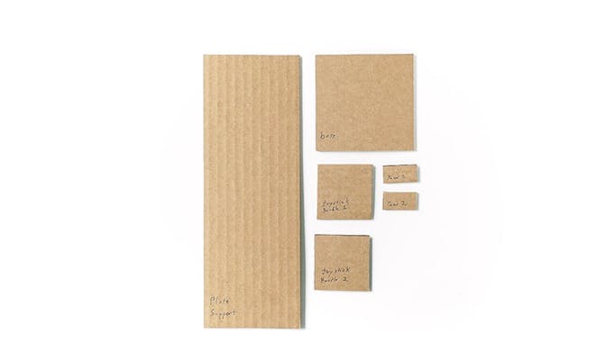 Cut the following pieces of cardboard: 9cm x 25cm, 9cm x 9cm, two pieces of 5cm x 5cm, and 2 pieces of 1cm x 3cm