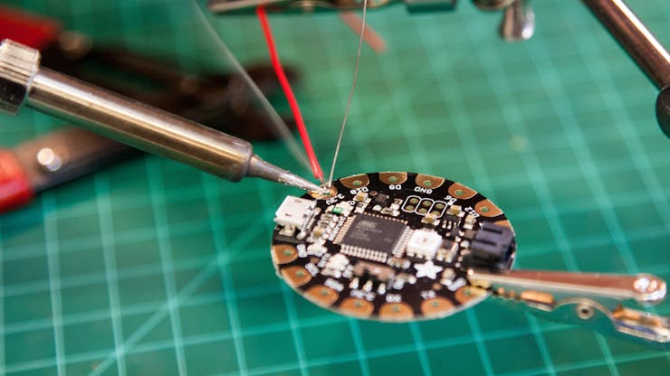 Solder your first wire to the pad marked 3.3V on the Flora.