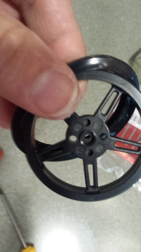 Slip rubber tire around plastic tire/rim/wheel
