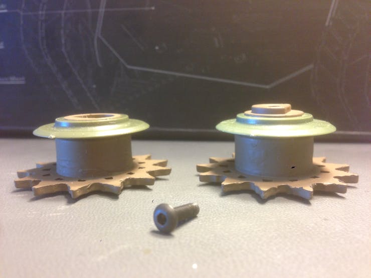 Half sprockets, with channel skirts facing toward the gear.